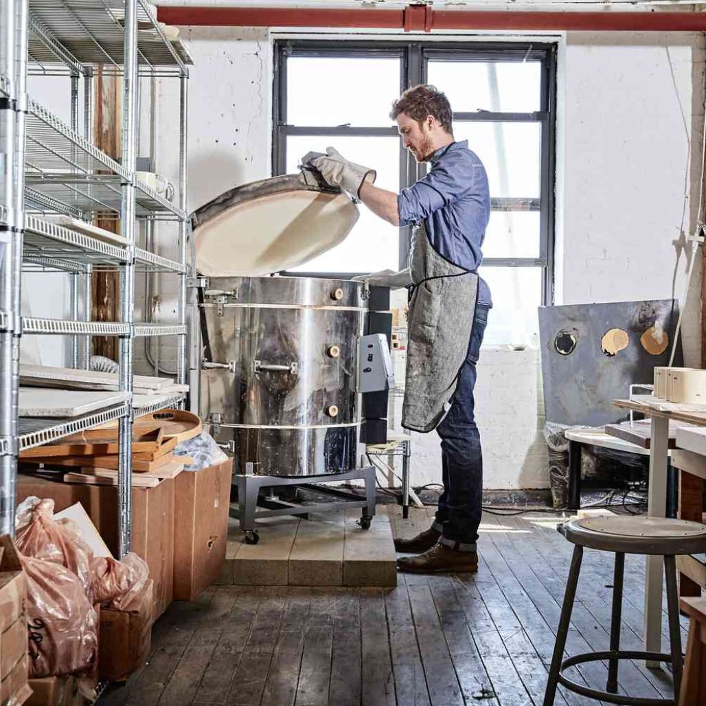 Top Loading Pottery Kiln Lid Being Opened By A Potter In The Studio