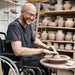 potter sculpting their creation on a special needs pottery wheel